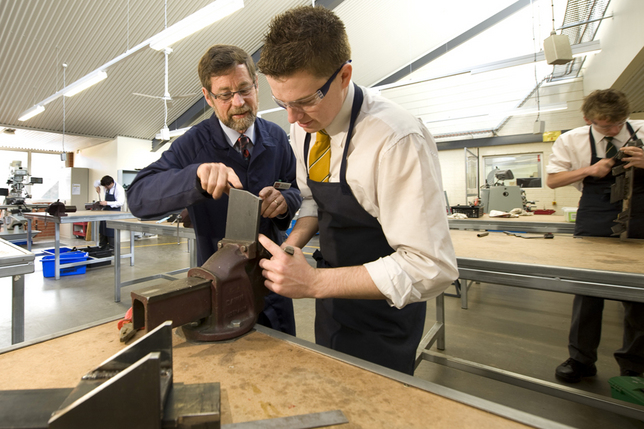 Tech teacher helping student